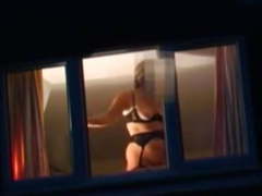 Voyeur watching neighbour at window.